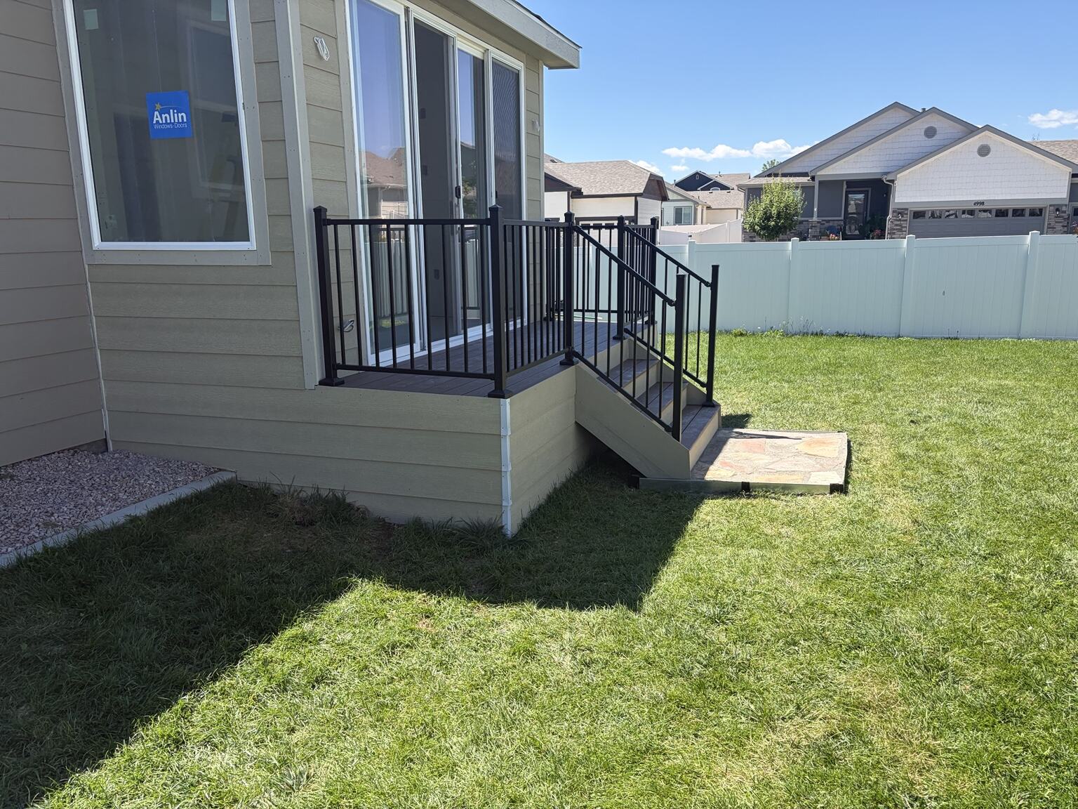 Finished compact deck, stairs, and black railing